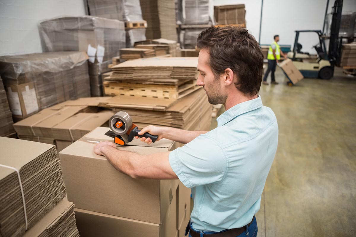 Warehouse worker preparing a shipment in a large warehouse